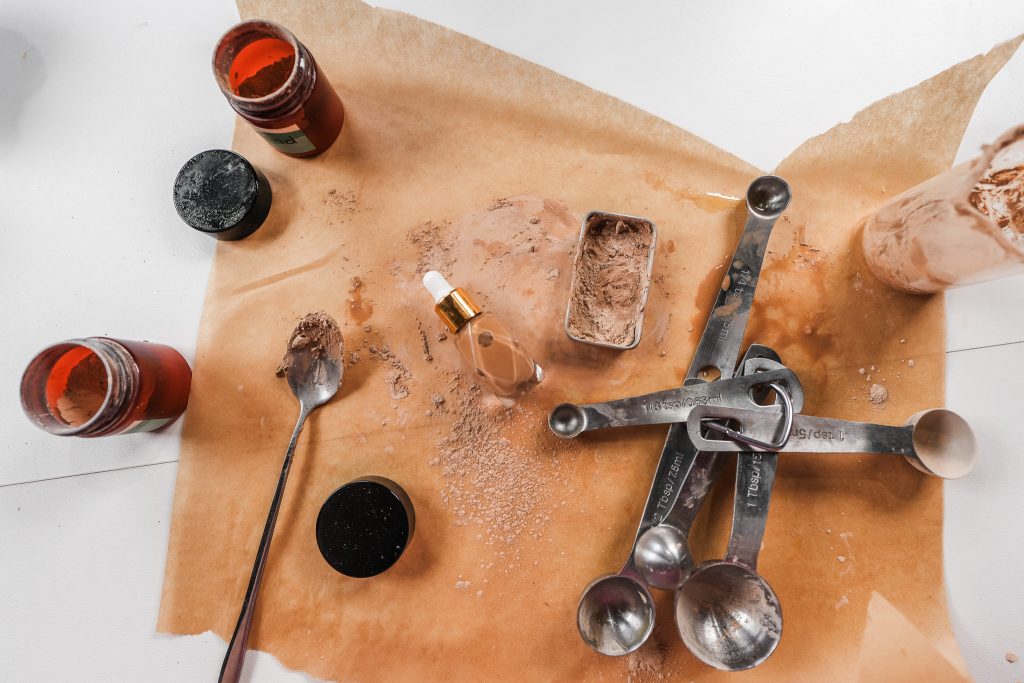 Homemade natural foundation—liquid and pressed powder—made with jojoba oil and DIY pigment blends